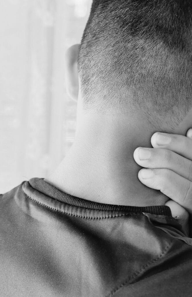 Child with hand on neck